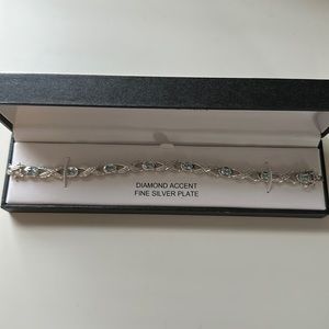 New without tag Sterling Silver Blue Topaz X and O Tennis Bracelet 7 1/2 Inches